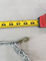 Measuring tape showing 58 inch length next to chain hook