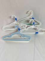 Close view of several hangers separated to display shape and notched design