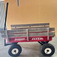 Full side view showing wood panels, red body, pull handle and tires