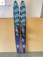 Full view of both Reflex water skis standing upright