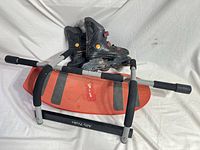 Skates stacked on balance board with Ally Peaks bar in foreground