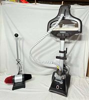 Rowenta garment steamer with hose and head beside Moneysworth shoe polisher
