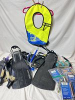 Full lot showing vest, fins, mask, snorkels, rearming kits