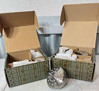 Both boxed Brizo body spray heads with contents visible