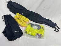 Overall lot view: cleats, shorts, pants, packaged jersey