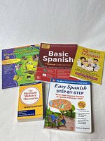 Five paperback books laid out showing covers