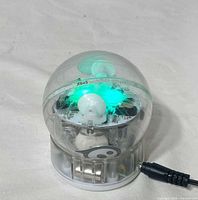 Robotic ball on charging base powered, LEDs lit