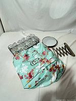 Accordion arm wall mirror, metal scroll tray and floral shower curtain