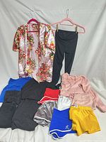 Full lot laid out showing all ten garments on backdrop