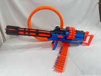 Right side view of X-Shot Insanity blaster with attached ammo ring and belt