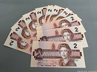 Fanned view of all ten $2 banknotes obverse side