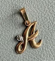 Front view of script A pendant with stone accent and bail