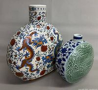 Front of both moon flasks showing designs and relative sizes