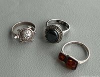 All three sterling silver rings side by side showing designs