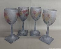 Front view of all four frosted floral wine glasses
