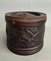 Front view of carved jar showing dragon detail