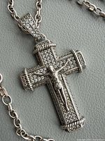 Front view of pavé stone crucifix pendant on chain