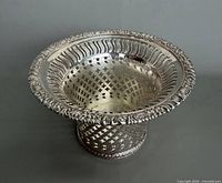 Top angle of silver-plated pierced coaster showing interior and rim detail