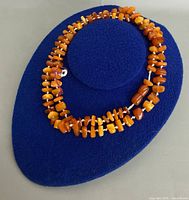Close view of amber chips and tube beads on blue form