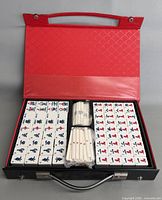 open case showing all mahjong tiles, sticks and dice