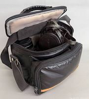 Camera bag open showing lenses and camera inside