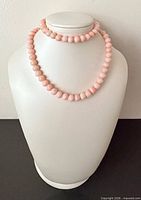 Necklace displayed doubled on bust showing bead uniformity and overall appearance