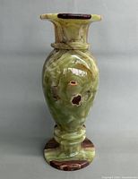 Front view of polished onyx vase showing green dominant side