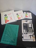 All items: three sealed Chalkola canvas panel packs, Royal & Langnickel sketching set, green cutting mat