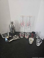 Full lot overview showing shaker, flutes, shot glasses, rocks glass, strainer and stoppers