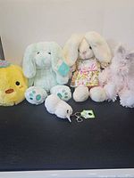 Group shot showing all five plush items