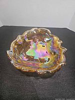 Top view of gold iridescent ruffled carnival glass dish