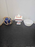 Lot overview of glass float, candy dish with lid, and iridescent bowl