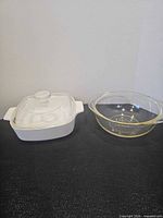 White ceramic casserole with lid and clear Pyrex bowl side by side