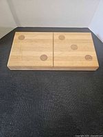 Front view showing domino design with central line and inlaid dots
