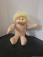 Full view of seated doll