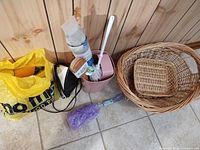Group shot showing iron, toilet brush with holder, yellow bag of brushes, bottle brush in packaging, purple brush head, nested baskets