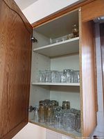 Cabinet view showing three shelves of assorted glassware