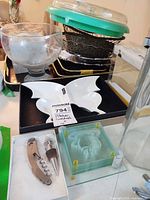 Overview of lot showing serving bowl, divided dish, coasters, corkscrew set, trays and additional items