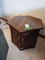 Three-quarter view of hexagonal table showing top and door