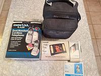Group shot showing phone box, Reebok bag, mirror box, Sanyo box and manual