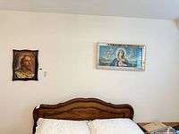 Both framed prints displayed above bed for scale and context