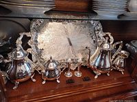 Full set displayed: tray, coffee pot, teapot, sugar bowl, creamer, candlesticks