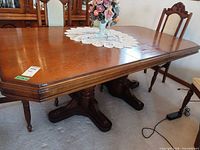 overall view of dining table with chairs and lace runner