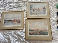 All three framed prints displayed on a bed