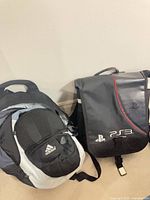 Adidas daypack and PS3 backpack side by side