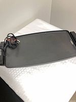 Top view of griddle showing cooking surface and cord