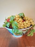 Bowl filled with assorted plastic grapes
