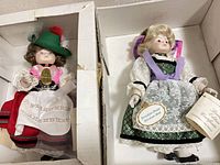 Both porcelain dolls in their boxes