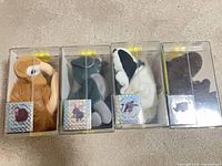 Four boxed Geo-Pals plush animals side by side