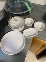 All six white CorningWare dishes on countertop